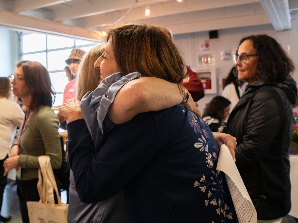 Two Women's Philanthropy members embracing at a Federation gathering
