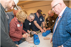 people being trained on stop the bleed exercise with blue foam