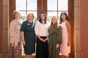 Women standing next to each other and smiling