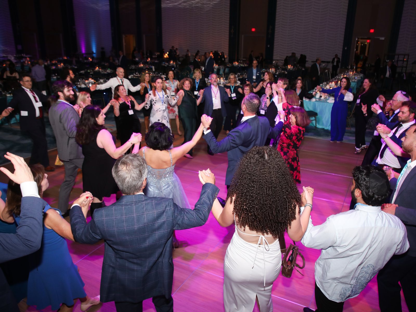 Community members dancing together in a circle at a Federation event