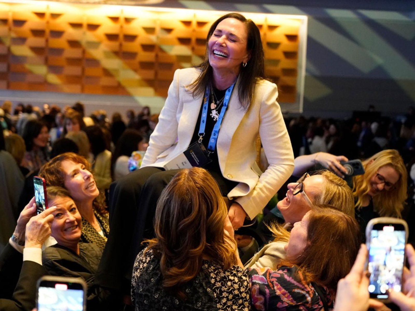 Women celebrating a leader at a Women&rsquo;s Philanthropy gathering
