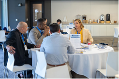 group of people sitting at a table, talking