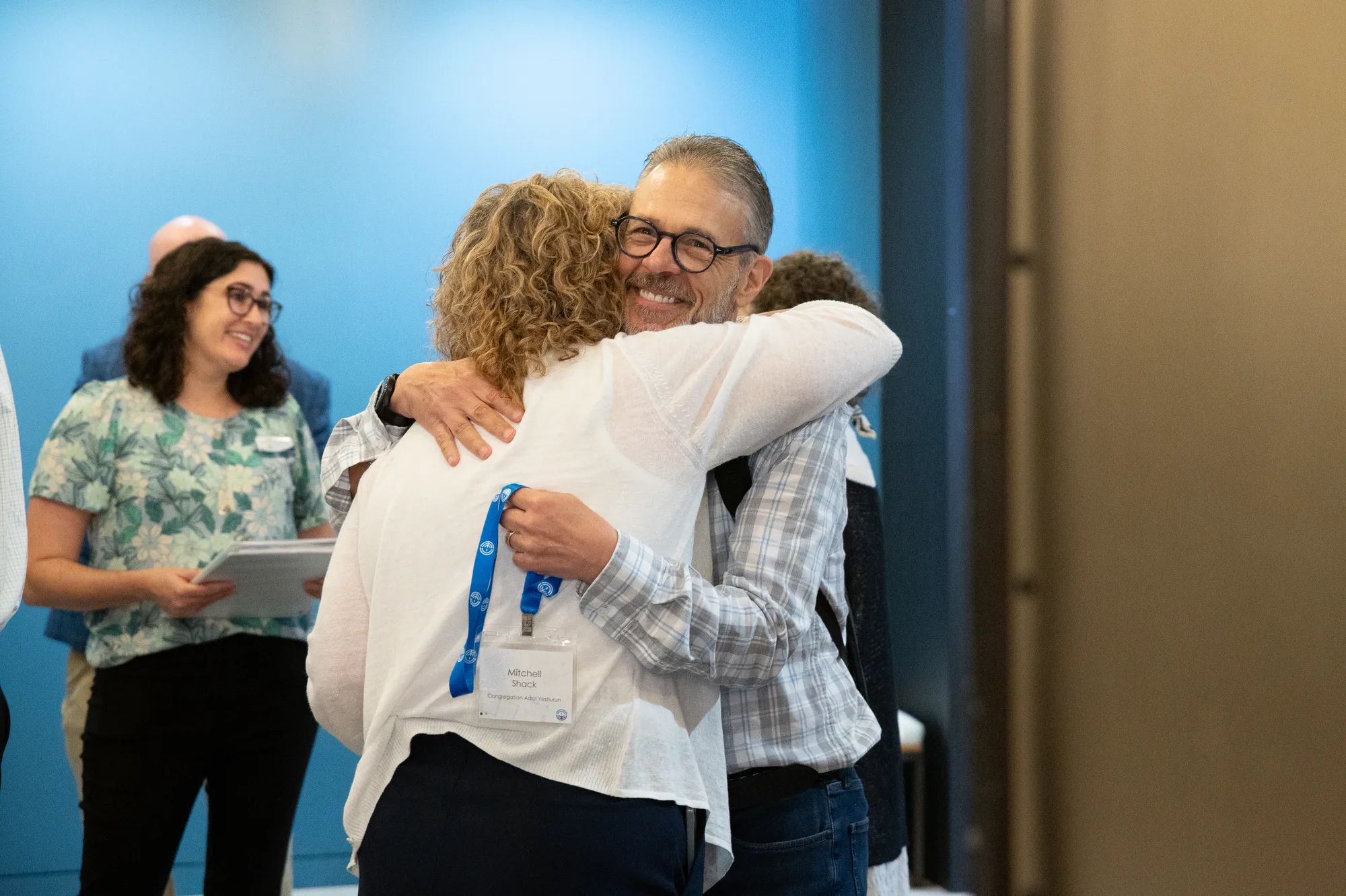Two people hugging at the Blueprint community forum