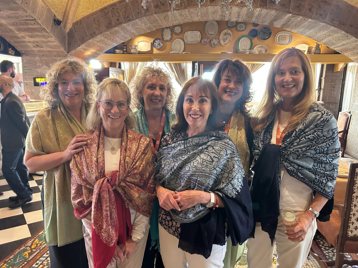 Women from the India mission wrapped in shawls inside a historic building