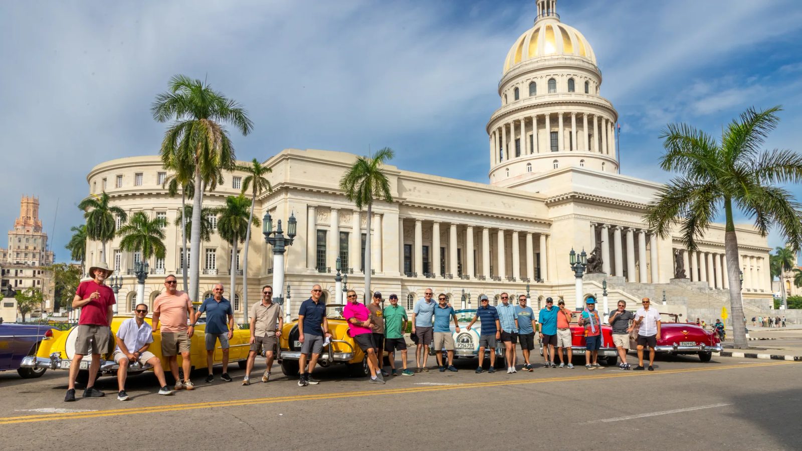 The Men's Mission to Cuba with vintage cars in front of the Capitolio in Havana