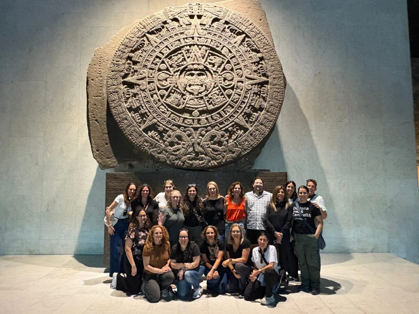 The Pauline Foster Women's Leadership Institute cohort beneath the Aztec sun stone
